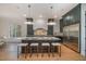Spacious eat-in kitchen with a large center island, modern lighting, and stainless steel appliances at 736 Golfers View Vw, Pittsboro, NC 27312