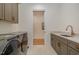 Well-equipped laundry room with stainless steel appliances and plenty of storage at 736 Golfers View Vw, Pittsboro, NC 27312