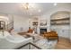 Cozy living room with a fireplace, built-in shelves, and an elegant light fixture at 736 Golfers View Vw, Pittsboro, NC 27312