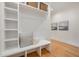 Well-organized mudroom with a built-in bench, storage shelves, and decorative wall art at 736 Golfers View Vw, Pittsboro, NC 27312