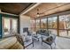Relaxing screened-in back patio with comfortable seating, a fireplace, and wooded views at 736 Golfers View Vw, Pittsboro, NC 27312