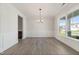 Spacious dining area featuring wainscotting, natural light, and light, wood-look flooring at 1224 Cricket St, Elon, NC 27244