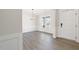 Bright dining room with beautiful hardwood floors, chandelier lighting and large windows at 1224 Cricket St, Elon, NC 27244