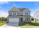 Charming two-story home featuring a stone-accented front, attached garage, and well-manicured lawn at 1224 Cricket St, Elon, NC 27244
