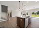 Open-concept kitchen features a large island, stainless steel appliances, and seamless flow to the living area at 1224 Cricket St, Elon, NC 27244