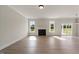 A bright living room showcasing a fireplace, large windows and sliding glass door, and light hardwood style flooring at 1224 Cricket St, Elon, NC 27244