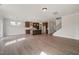 Open-concept space featuring a modern kitchen and living area, complete with staircase and hardwood style flooring at 1224 Cricket St, Elon, NC 27244