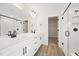 Modern bathroom featuring double vanity, white countertops, black hardware, walk in shower, and vinyl flooring at 1228 Cricket St, Elon, NC 27244