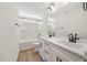 Modern bathroom featuring double vanity, quartz countertops, black hardware, tub and shower combo, and vinyl flooring at 1228 Cricket St, Elon, NC 27244