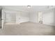 Large bedroom featuring neutral carpet, tray ceiling, and attached bathroom and walk-in closet at 1228 Cricket St, Elon, NC 27244