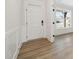 Bright foyer with wood flooring, white trim, and a view of the front porch at 1228 Cricket St, Elon, NC 27244
