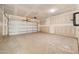 Spacious two-car garage with concrete floor and open ceiling at 1228 Cricket St, Elon, NC 27244