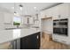 Bright kitchen with white cabinetry, pendant lights, and stainless appliances at 1228 Cricket St, Elon, NC 27244