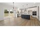 Eat-in kitchen with white cabinets, a center island, and sliding door access at 1228 Cricket St, Elon, NC 27244