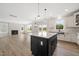 Open concept kitchen with a large island, granite countertops, and stainless steel appliances at 1228 Cricket St, Elon, NC 27244