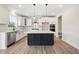 Modern kitchen with stainless steel appliances, white cabinets, and an island at 1228 Cricket St, Elon, NC 27244