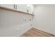Neat laundry room with washer and dryer hookups and ample upper cabinet space at 1228 Cricket St, Elon, NC 27244