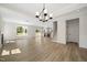 Open-concept living room boasts hardwood floors, fireplace, and a view of the kitchen at 1228 Cricket St, Elon, NC 27244