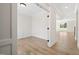 Open-concept living space with bright white walls and wood floors, bathed in natural light at 1228 Cricket St, Elon, NC 27244