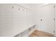Bright mudroom features built-in bench with storage and coat hooks at 1228 Cricket St, Elon, NC 27244