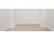 Bright, walk-in closet with neutral carpet and white walls, offering ample storage space with a minimalist design at 1228 Cricket St, Elon, NC 27244