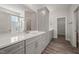 Bathroom featuring double vanities, a large mirror, and a glass enclosed shower with subway tiles at 1232 Cricket St, Elon, NC 27244