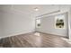Bright bedroom boasts a tray ceiling, hardwood floors, and large windows offering ample natural light at 1232 Cricket St, Elon, NC 27244