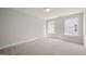 Bright bedroom featuring plush carpeting, neutral walls and two windows offering natural light at 1232 Cricket St, Elon, NC 27244