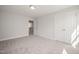 Cozy bedroom featuring neutral walls, plush carpeting, and a spacious closet with double doors at 1232 Cricket St, Elon, NC 27244