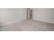 Inviting bedroom featuring neutral walls, plush carpeting, and an open doorway at 1232 Cricket St, Elon, NC 27244