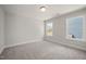 Bedroom featuring two windows and neutral carpet at 1232 Cricket St, Elon, NC 27244