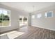 Bright dining room features natural light, hardwood flooring, and access to outdoor space at 1232 Cricket St, Elon, NC 27244