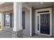 Close up of the front door and porch showcasing gray siding and a stone accent wall at 1232 Cricket St, Elon, NC 27244