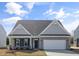 Charming single-story home featuring a stone facade, two-car garage, and well-maintained landscaping at 1232 Cricket St, Elon, NC 27244