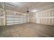 Unfinished garage featuring concrete floors, lighting and garage door at 1232 Cricket St, Elon, NC 27244