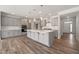 Spacious kitchen featuring gray cabinets, stainless steel appliances, and an oversized center island at 1232 Cricket St, Elon, NC 27244