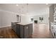Kitchen with center island and sink. Open to the living room with a fireplace at 1232 Cricket St, Elon, NC 27244