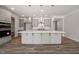 Large kitchen featuring an island, pendant lights, and stainless steel appliances at 1232 Cricket St, Elon, NC 27244