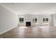 Bright living room boasts hardwood floors, fireplace, and natural light from many windows at 1232 Cricket St, Elon, NC 27244