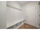 Mudroom featuring a bench, storage, coat hooks, and access to the garage at 1232 Cricket St, Elon, NC 27244