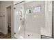 Close up shot of the large tiled shower with a glass door and a built in bench at 1232 Cricket St, Elon, NC 27244