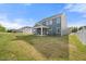 Large backyard with a covered patio and green grass, perfect for entertaining at 1301 Cricket St, Elon, NC 27244