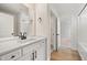 New bathroom featuring a quartz countertop, black hardware, and modern fixtures at 1301 Cricket St, Elon, NC 27244