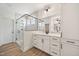 Bright bathroom featuring a glass enclosed shower, large mirror, and white vanity at 1301 Cricket St, Elon, NC 27244