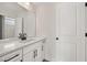 Modern bathroom featuring white cabinets, black hardware, and a large frameless mirror at 1301 Cricket St, Elon, NC 27244