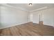 Spacious bedroom featuring hardwood floors, white walls and trim, and recessed ceiling lights at 1301 Cricket St, Elon, NC 27244
