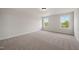 Bright bedroom with neutral walls and carpet showcasing great natural light at 1301 Cricket St, Elon, NC 27244