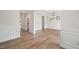 Spacious room with hardwood floors, decorative molding, open to other living areas at 1301 Cricket St, Elon, NC 27244