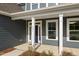 Close-up of the home's entry with a blue door, address numbers, and white columns at 1301 Cricket St, Elon, NC 27244