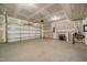 Unfinished two car garage with a garage door opener and concrete flooring at 1301 Cricket St, Elon, NC 27244